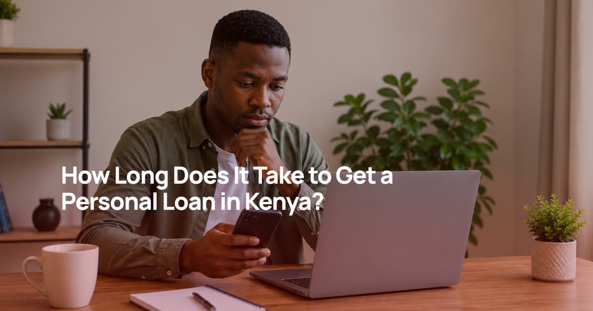 A Kenyan man reviewing loan application documents on his laptop while checking his phone during the personal loan application process.